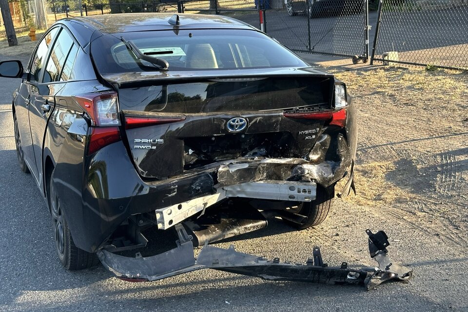 Prius with the rear end smashed, the bumper crushed into a V shape.jpg